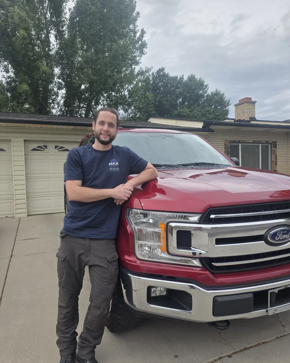 Mackay, owner and lead technician at Max Mechanical Services, with the company truck in Mapleton, Utah